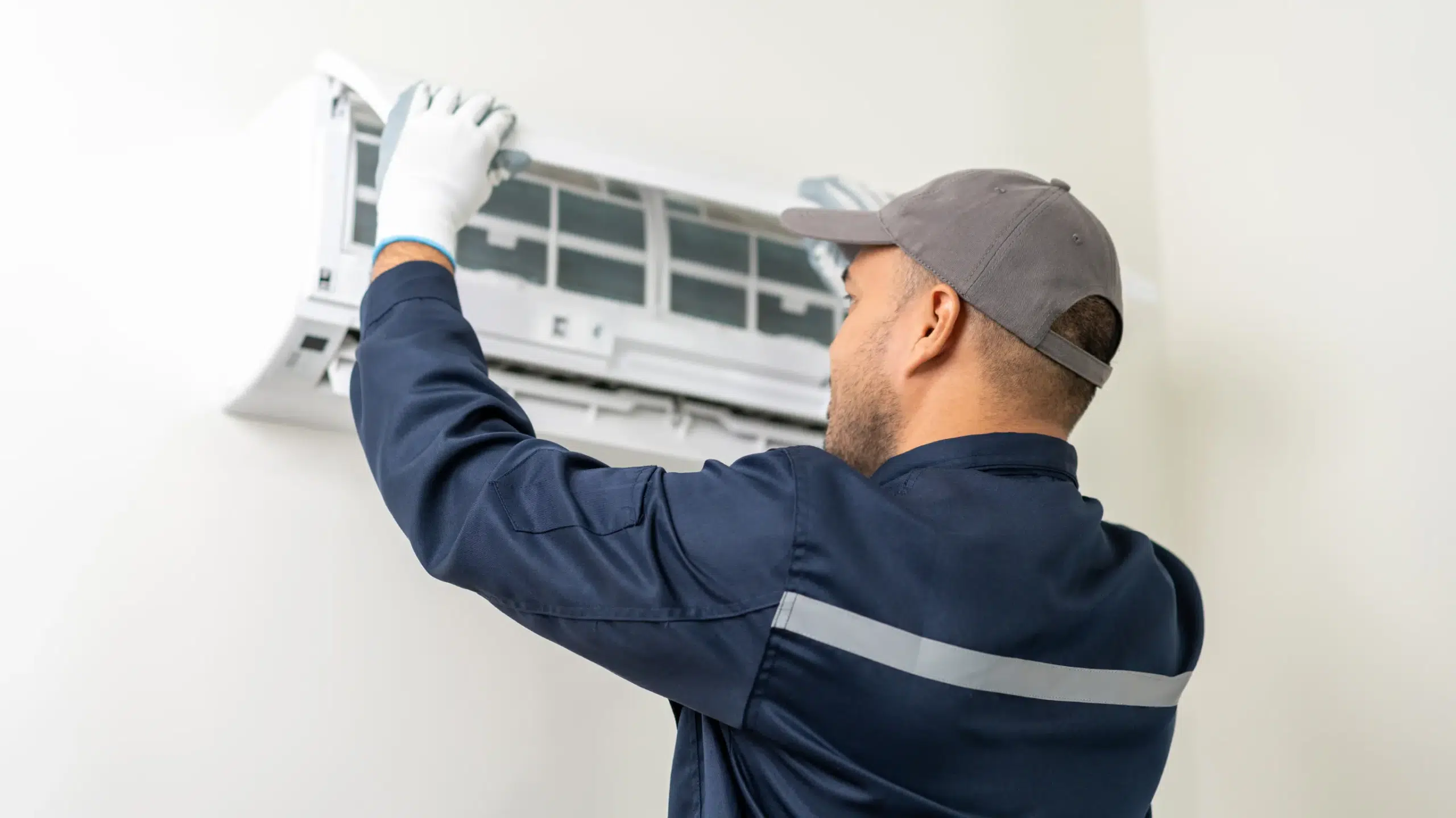 A man fixing an ac smelling musty