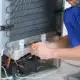 Fridge technician working on fridge regassing