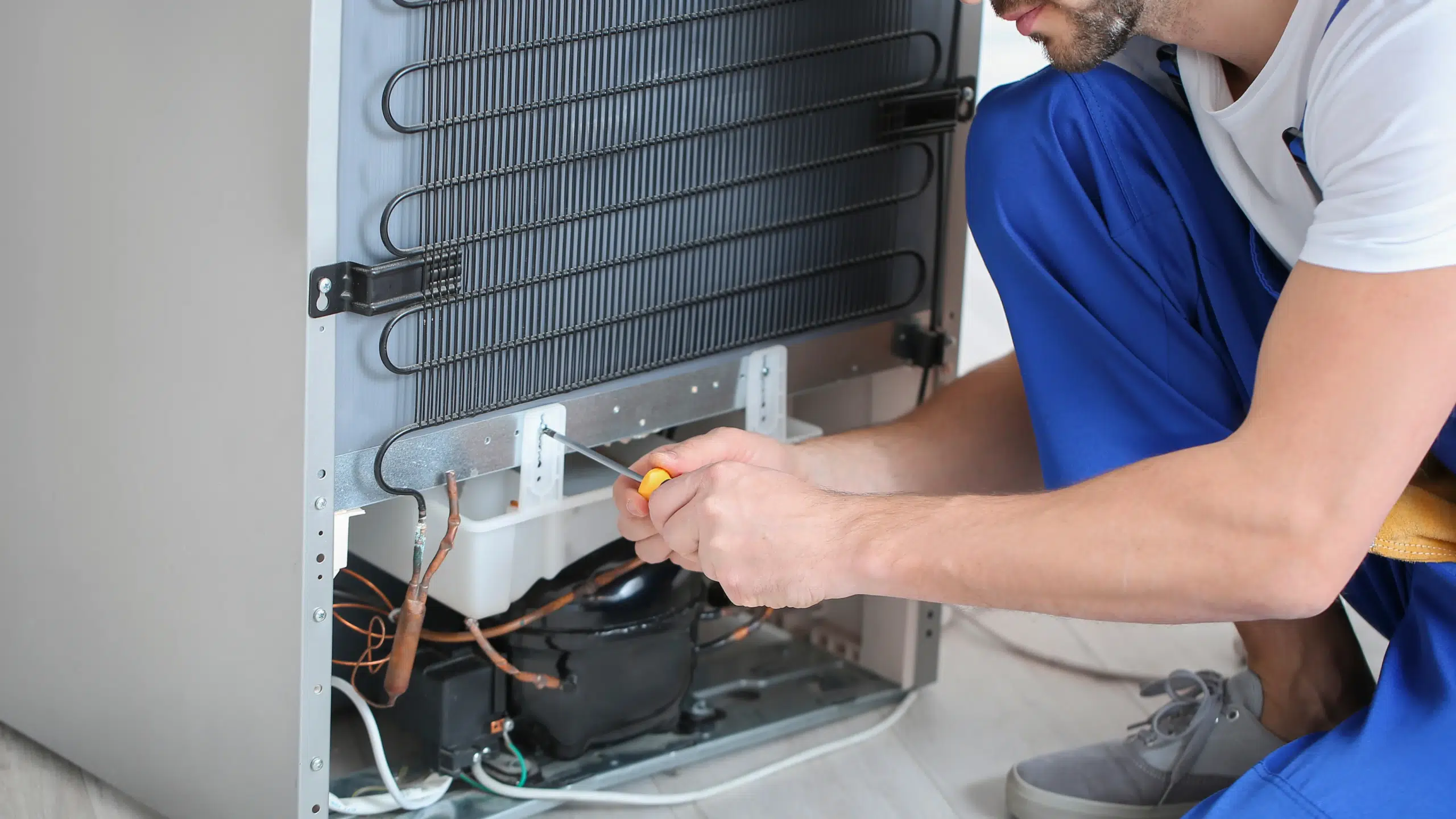 Fridge technician working on fridge regassing