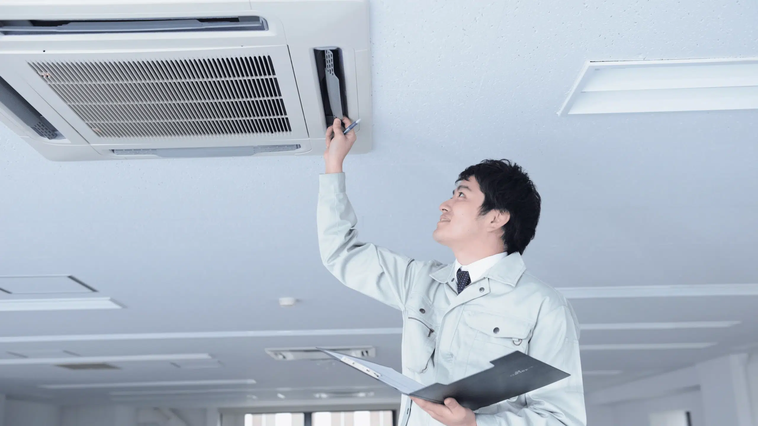 scientist having a look at cassette air conditioning